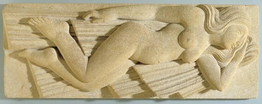 Carved image of a naked woman sleeping.