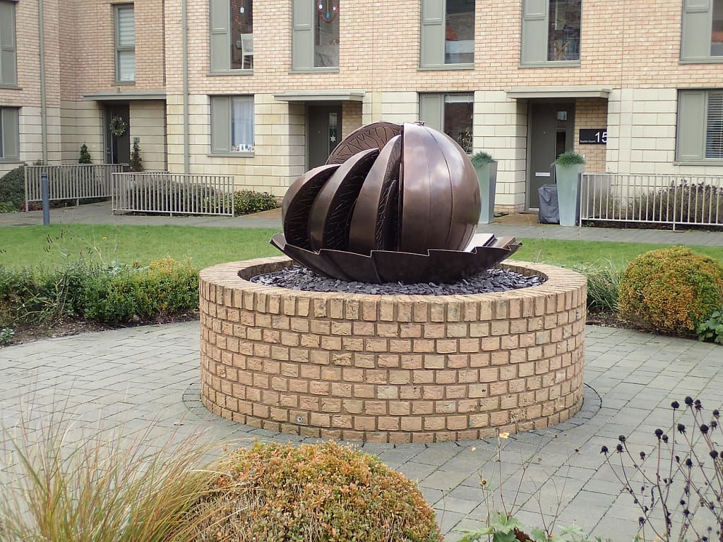 Modern bronze sculpture in a residential block.