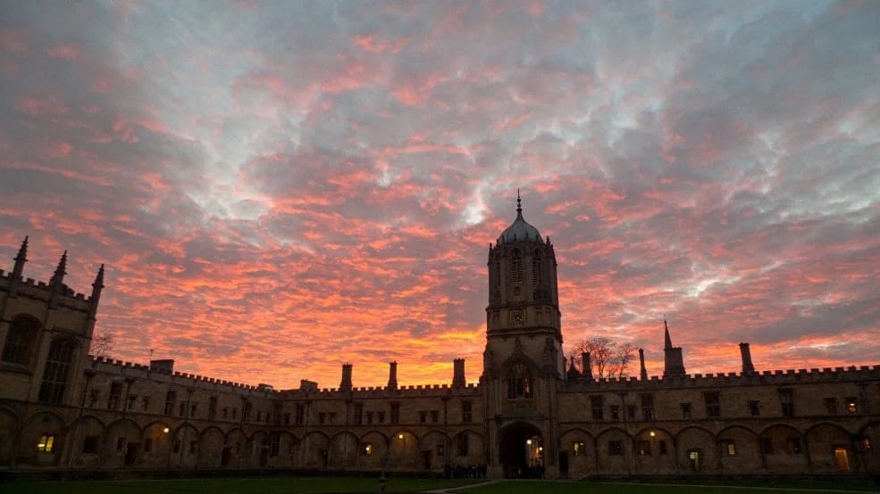 Sunset with the skyline of a castle-like Oxford college