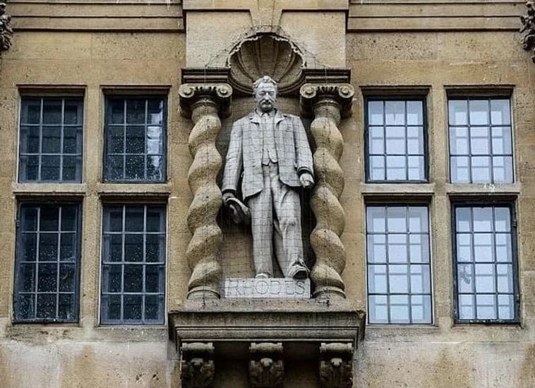 The statue of Cecil Rhodes on the Rhodes building of Oriel College, High Street, Oxford, is dressed like a businessman. This is only one of many images of Rhodes which appear across the university and city.
