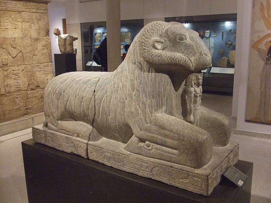Ancient Egyptian stone carving of a seated ram. 