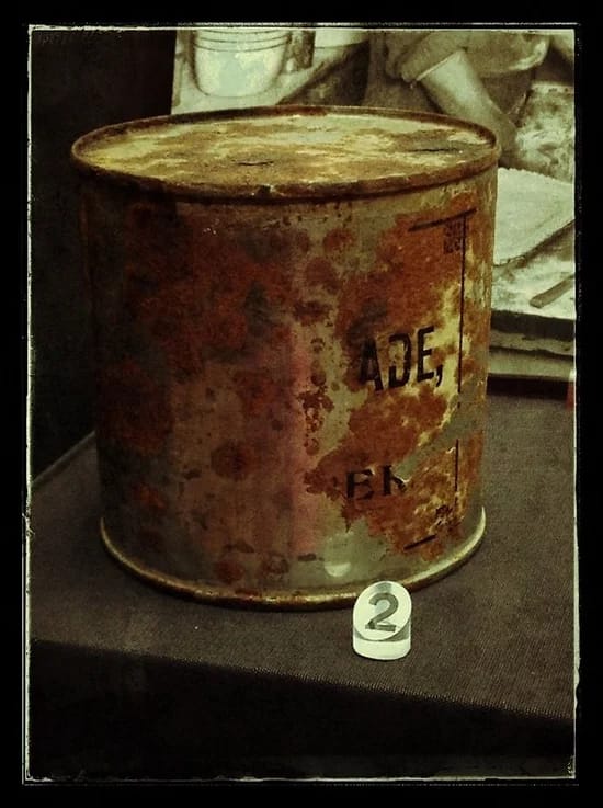 Picture of an old rusty can within a museum exhibit.