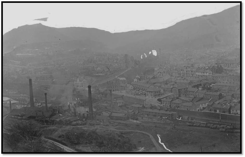 Black and white archive photo for an industrial town with visible chimneys and factories. 